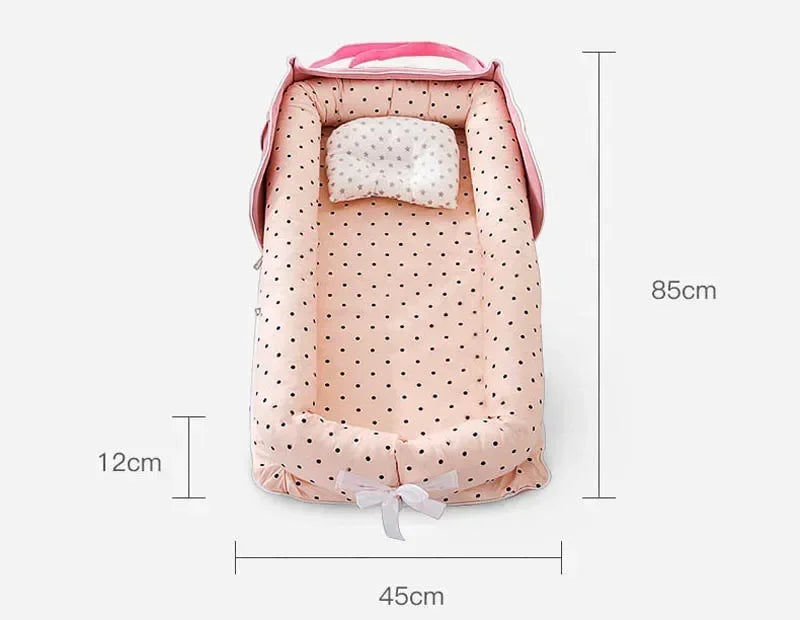 Réducteur de lit bébé rose à pois
